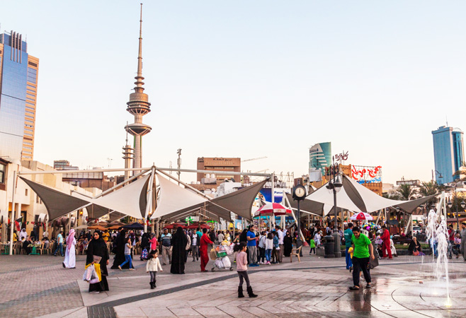 People on a pedestrian zone in central Kuwait City