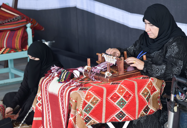 Women make a traditional sadu weaving