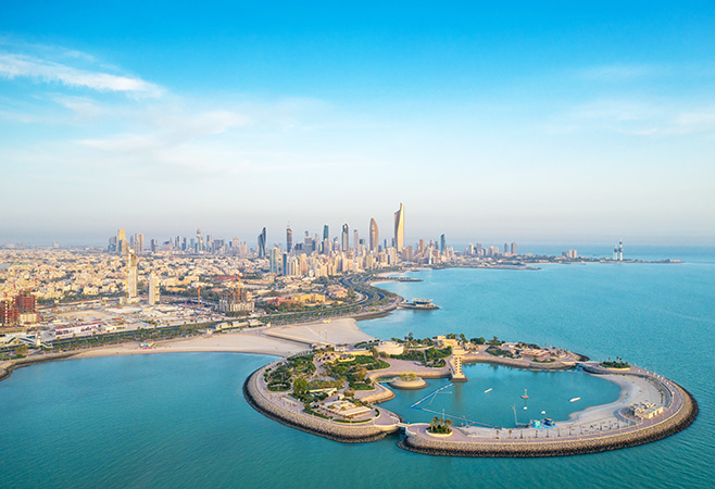 A high-angle shot of The Green Island with a skyline of the city of Kuwait in the background