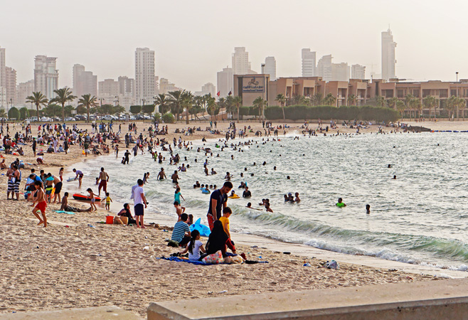People at marina beach at Persian gulf coast warm summer day travel vacation