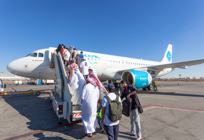 Jazeera Airways airplane boarding at the Kuwait International Airport