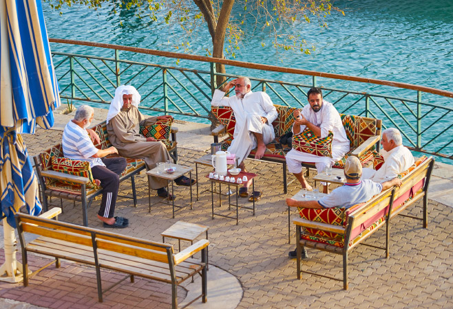 Men at the benches with the tea and talking